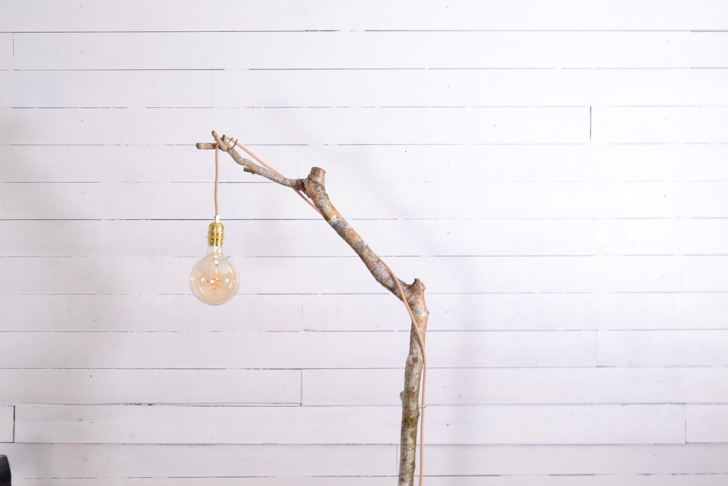 Lampadaire design bohème en bois avec une branche de noisetier